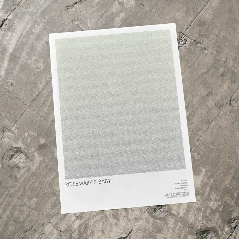 A Rosemary's Baby movie script poster laid flat on a textured floor surface.