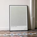 A framed Rosemary's Baby movie script poster leaning against a wall in a minimalist interior.