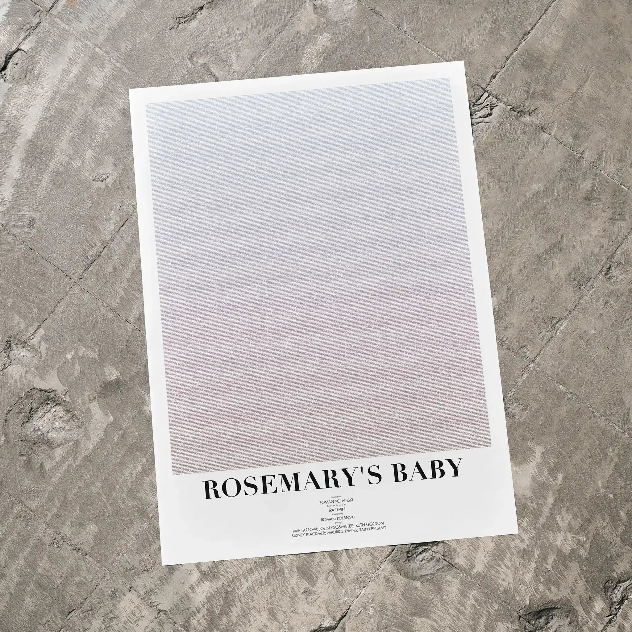 A Rosemary's Baby movie script poster laid flat on a textured floor surface.