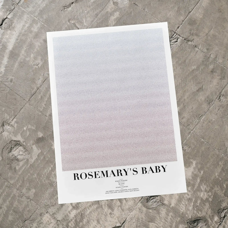 A Rosemary's Baby movie script poster laid flat on a textured floor surface.