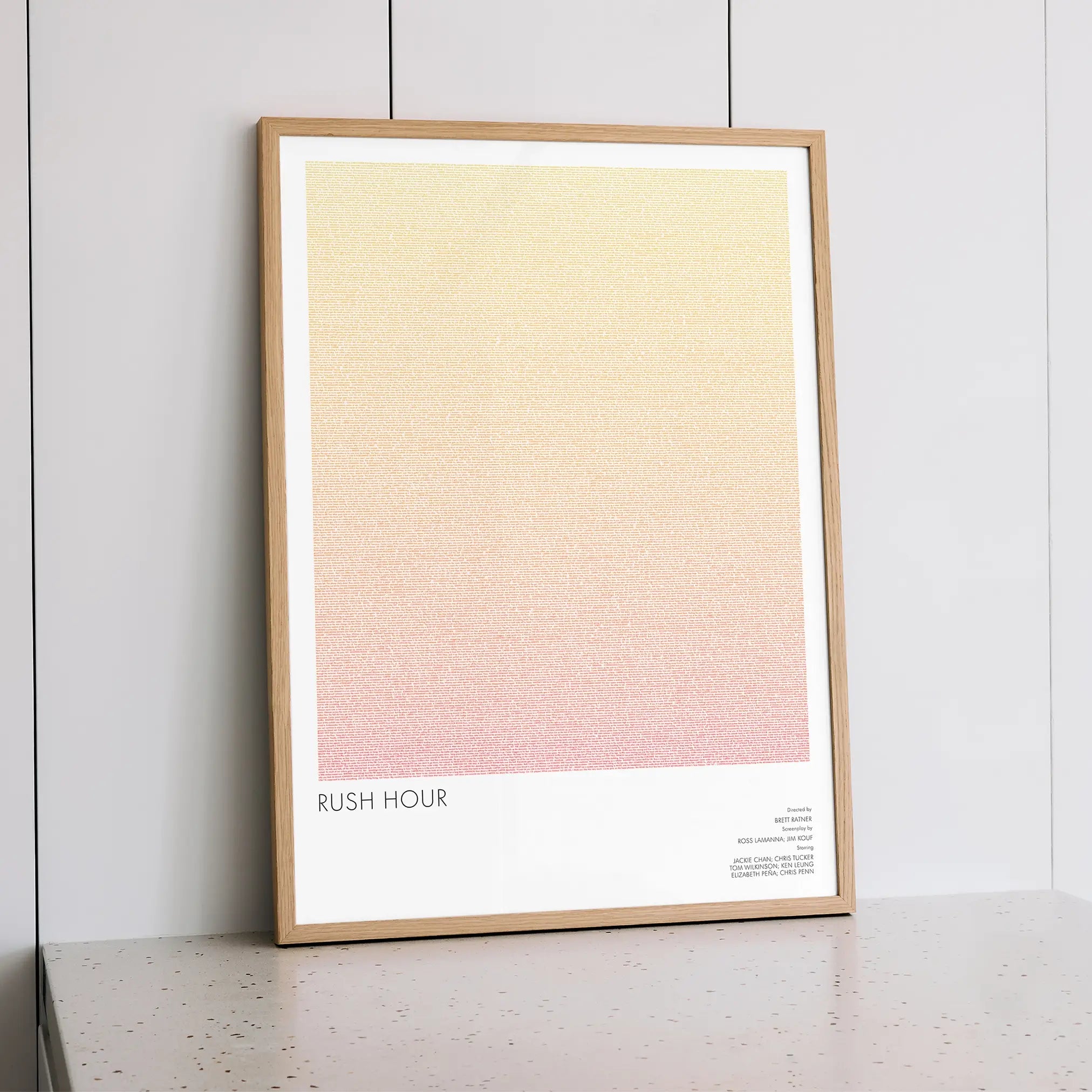A framed Rush Hour movie script poster styled within a calm interior space.