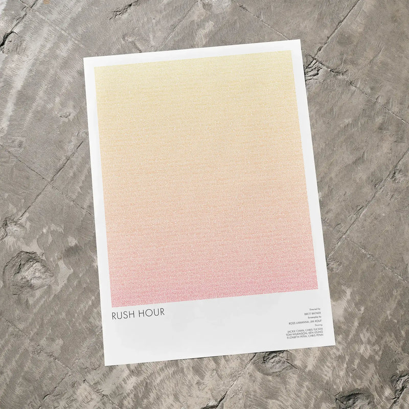 A Rush Hour movie script poster laid flat on a textured floor surface.