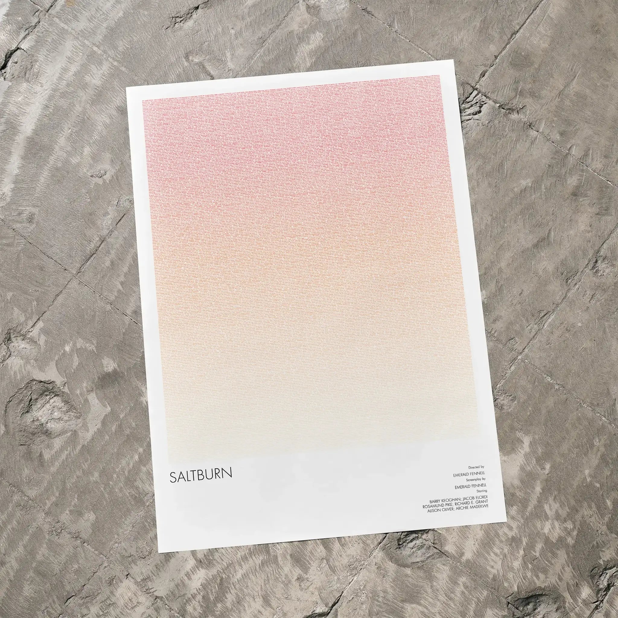 A Saltburn movie script poster laid flat on a textured floor surface.