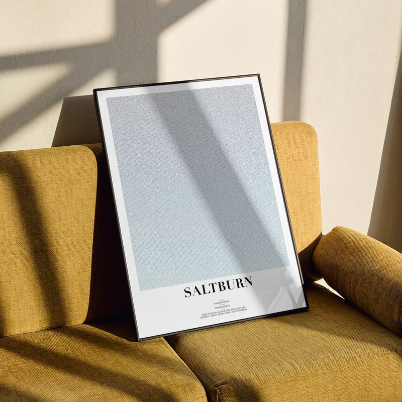 A framed Saltburn movie script poster styled in a clean interior setting.