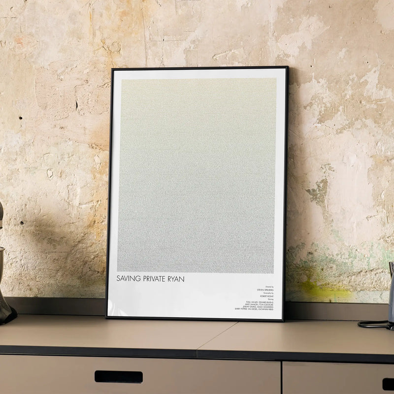 A framed Saving Private Ryan movie script poster displayed on a cabinet in a minimalist interior.