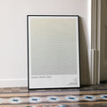 A framed Saving Private Ryan movie script poster leaning against a wall in a minimalist interior.