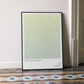 Framed poster with 'Sense and Sensibility' text on a light green background, leaning against a wall.