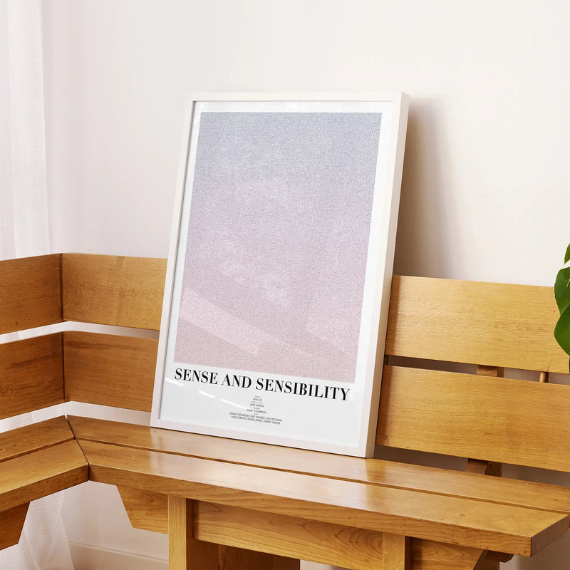 A framed Sense and Sensibility movie script poster displayed on a sideboard in a contemporary space.