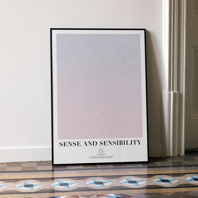 A framed Sense and Sensibility movie script poster leaning against a wall in a minimalist interior.