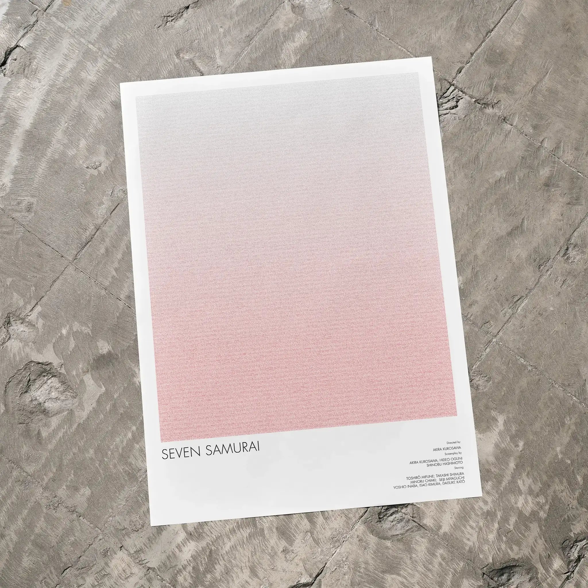 A Seven Samurai movie script poster laid flat on a textured floor surface.