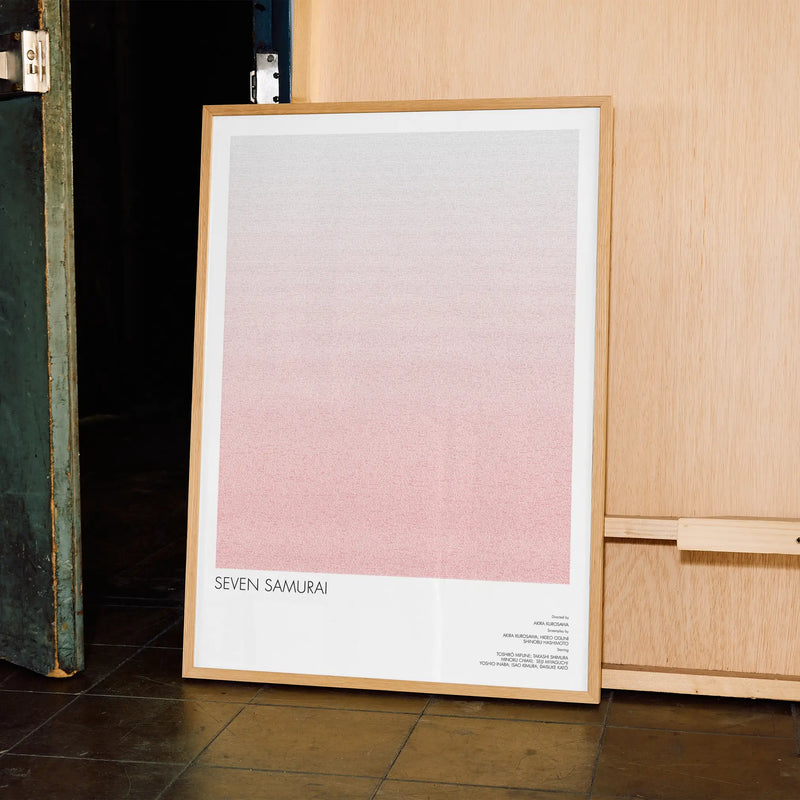 A framed Seven Samurai movie script poster displayed in a contemporary interior setting.