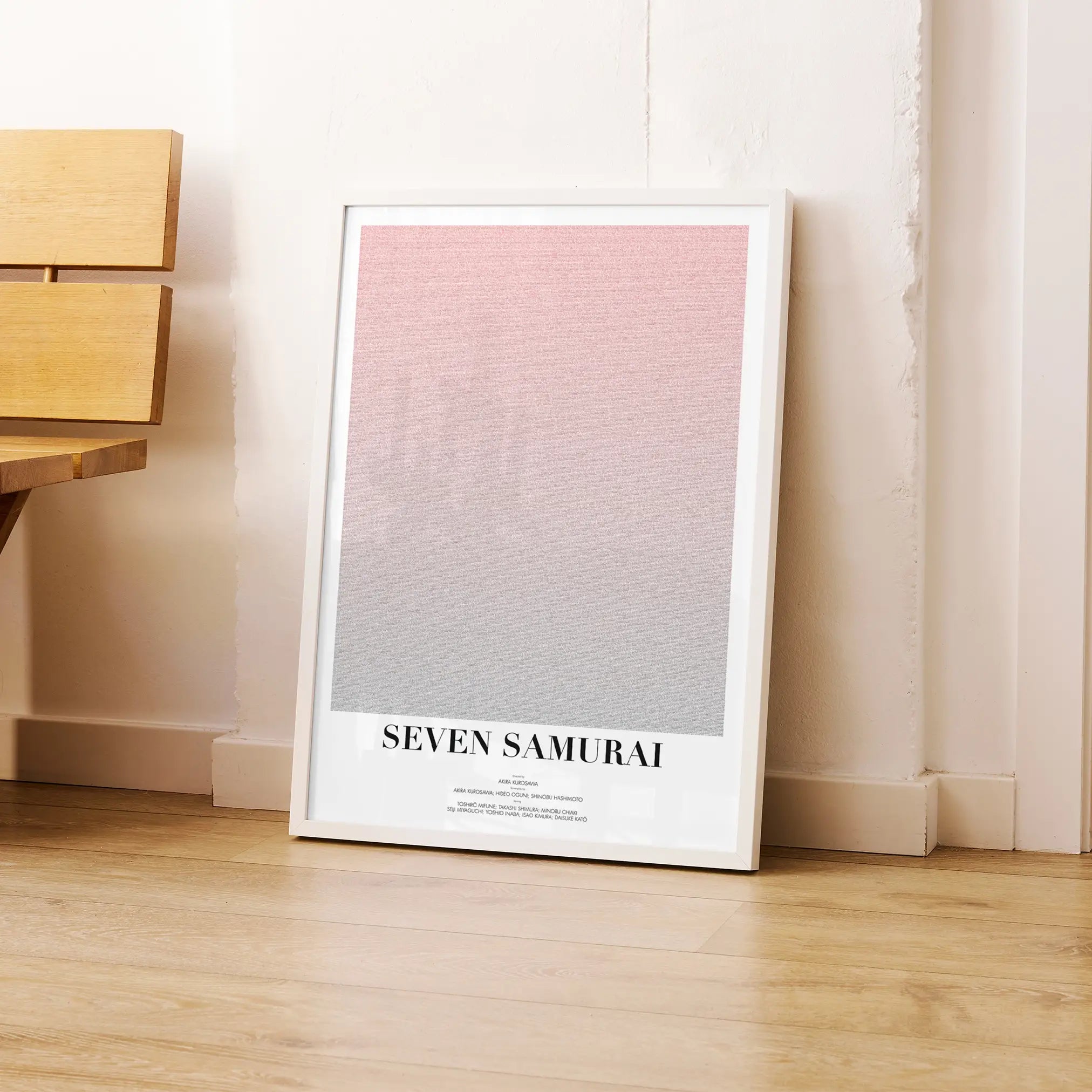 A framed Seven Samurai movie script poster leaning against a wall in a modern interior.