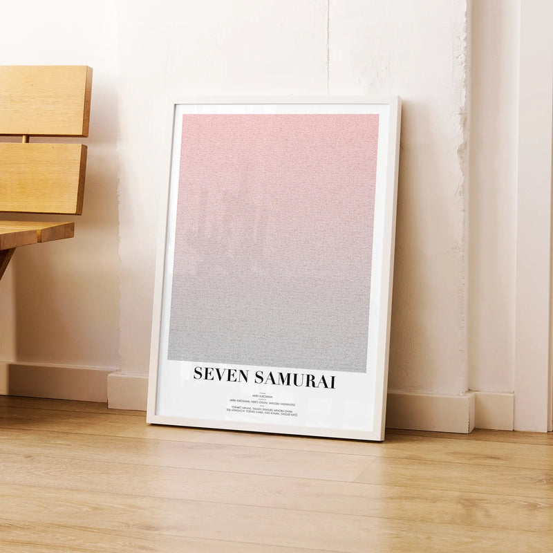 A framed Seven Samurai movie script poster leaning against a wall in a modern interior.