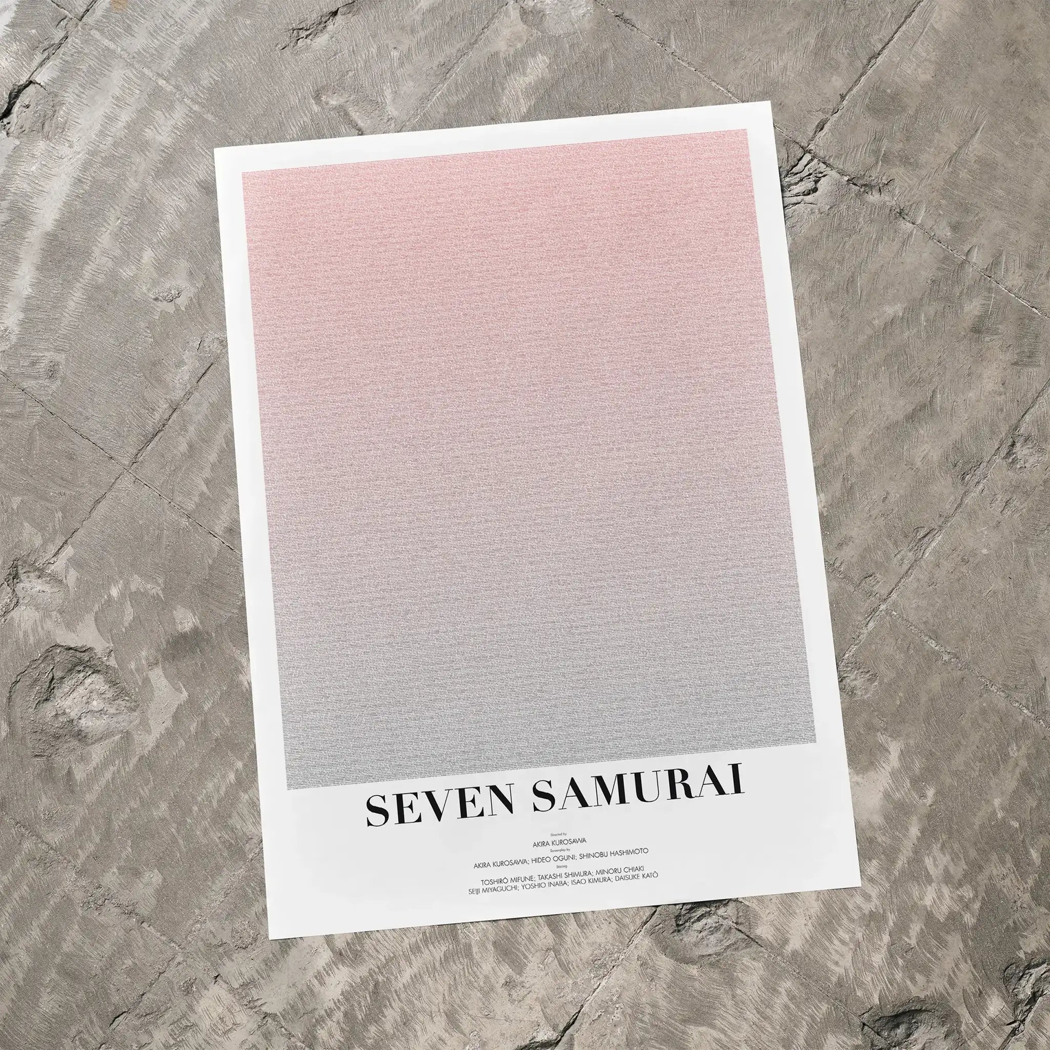 A Seven Samurai movie script poster laid flat on a textured floor surface.