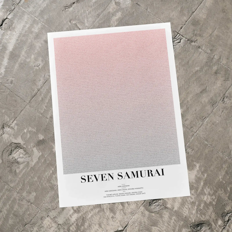 A Seven Samurai movie script poster laid flat on a textured floor surface.