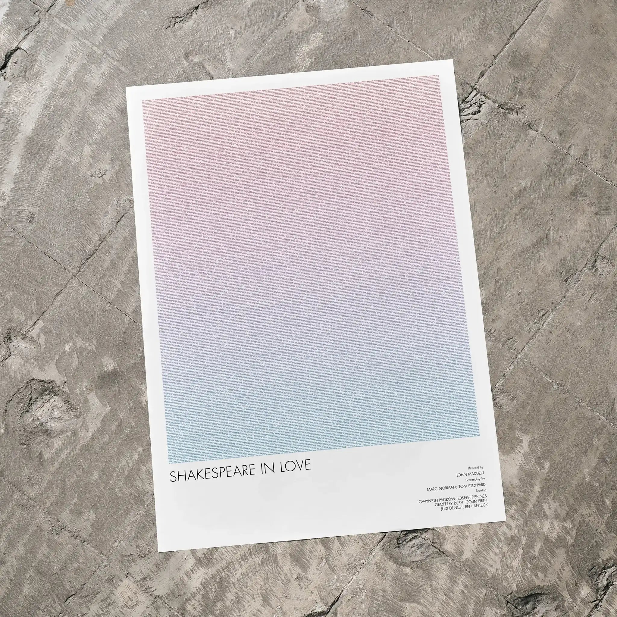 A Shakespeare in Love movie script poster laid flat on a textured floor surface.