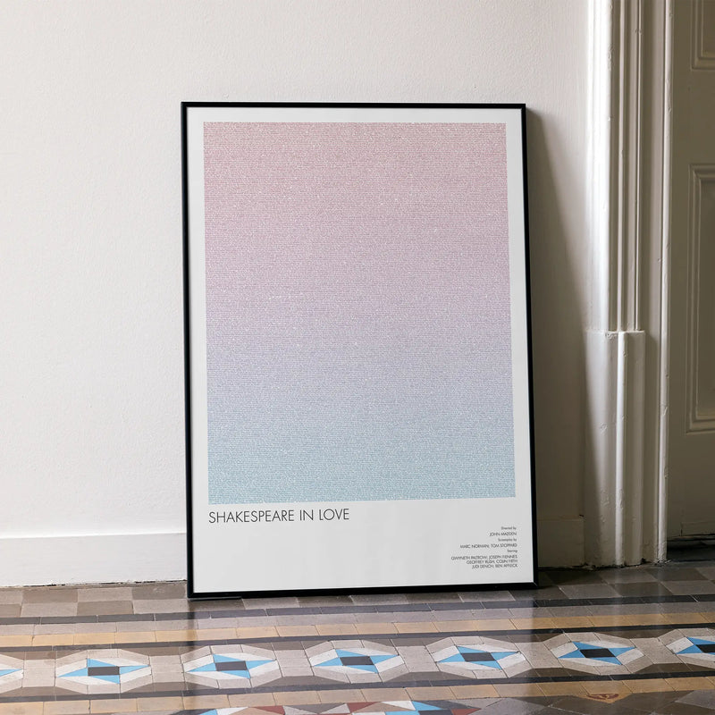 A framed Shakespeare in Love movie script poster leaning against a wall in a minimalist interior.