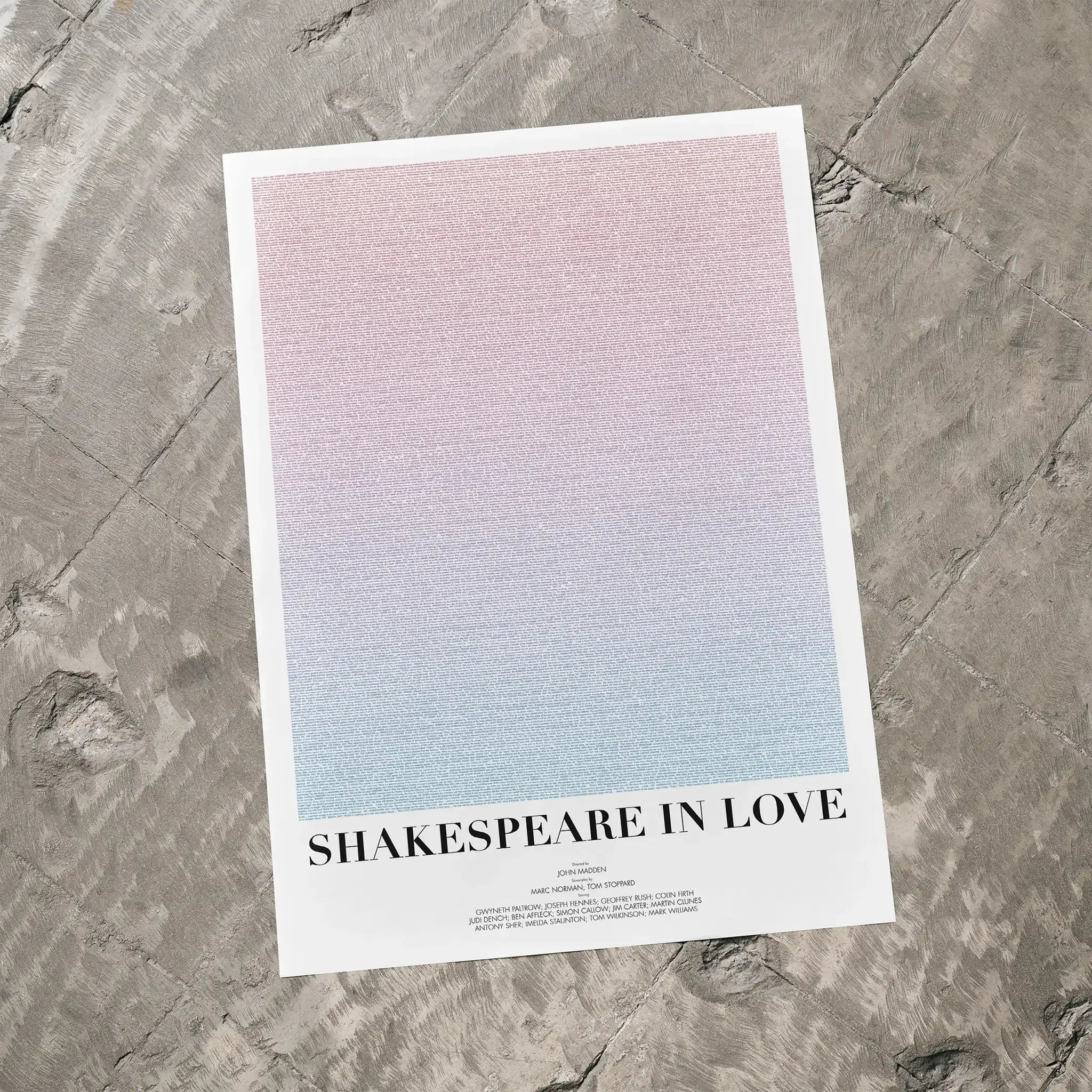 A Shakespeare in Love movie script poster laid flat on a textured floor surface.