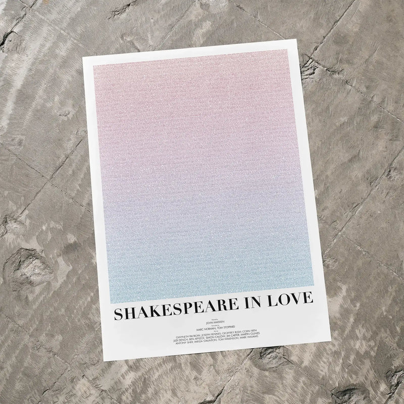 A Shakespeare in Love movie script poster laid flat on a textured floor surface.