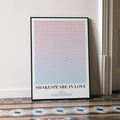 A framed Shakespeare in Love movie script poster leaning against a wall in a minimalist interior.