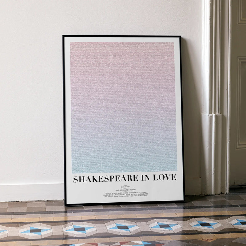 A framed Shakespeare in Love movie script poster leaning against a wall in a minimalist interior.