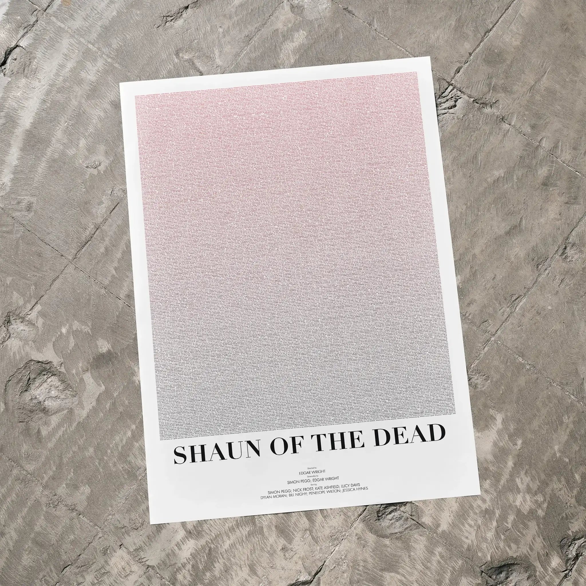 A Shaun of the Dead movie script poster laid flat on a textured floor surface.