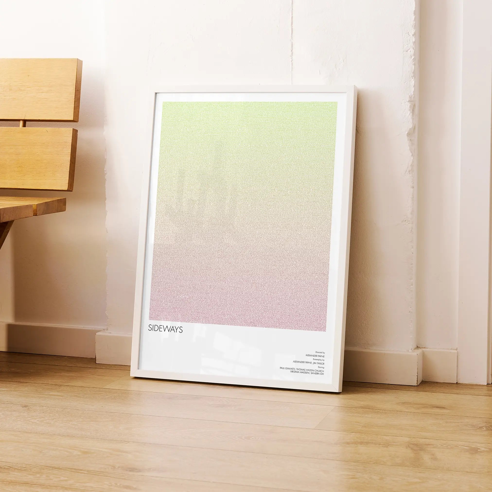 A framed Sideways movie script poster leaning against a wall in a modern interior.