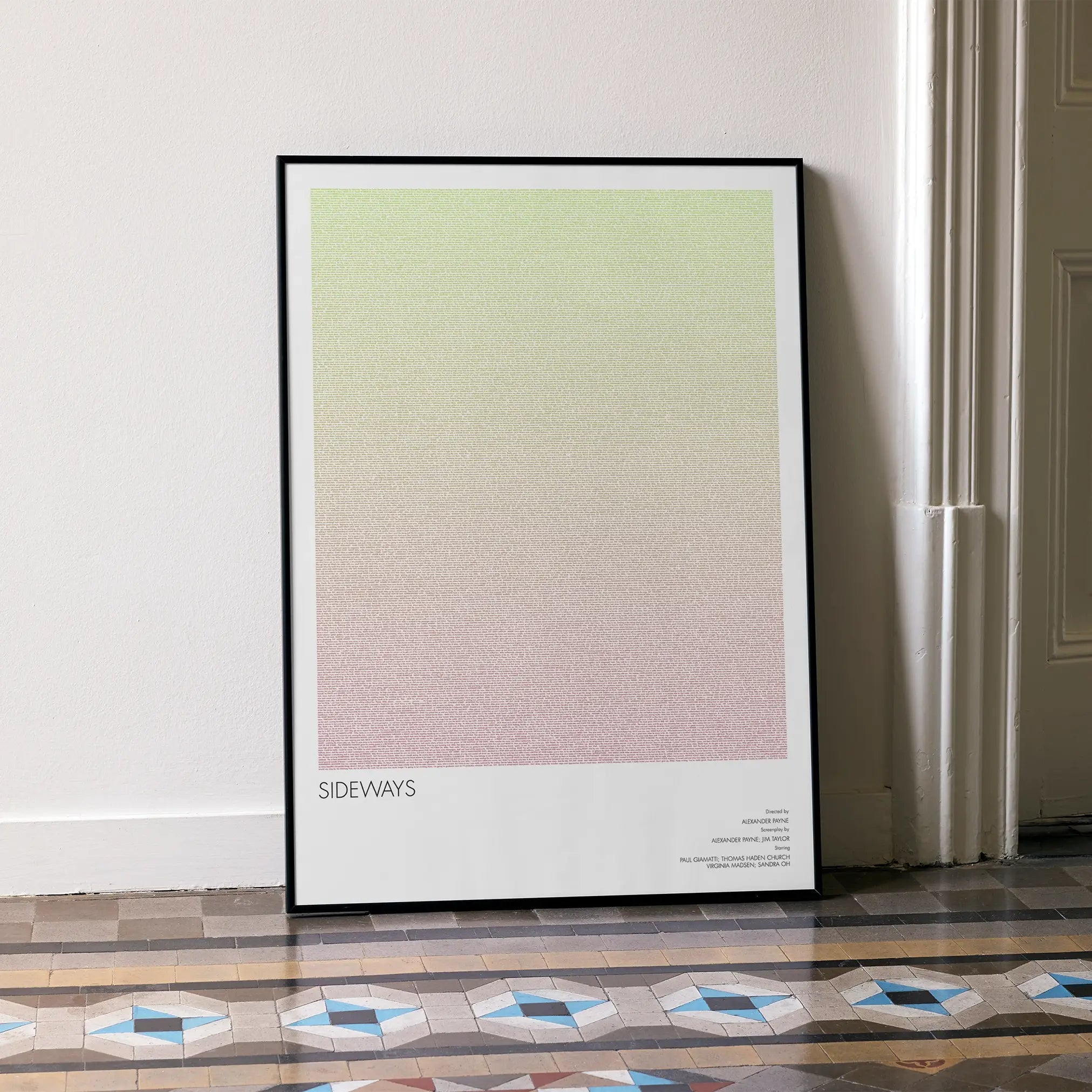 A framed Sideways movie script poster leaning against a wall in a minimalist interior.
