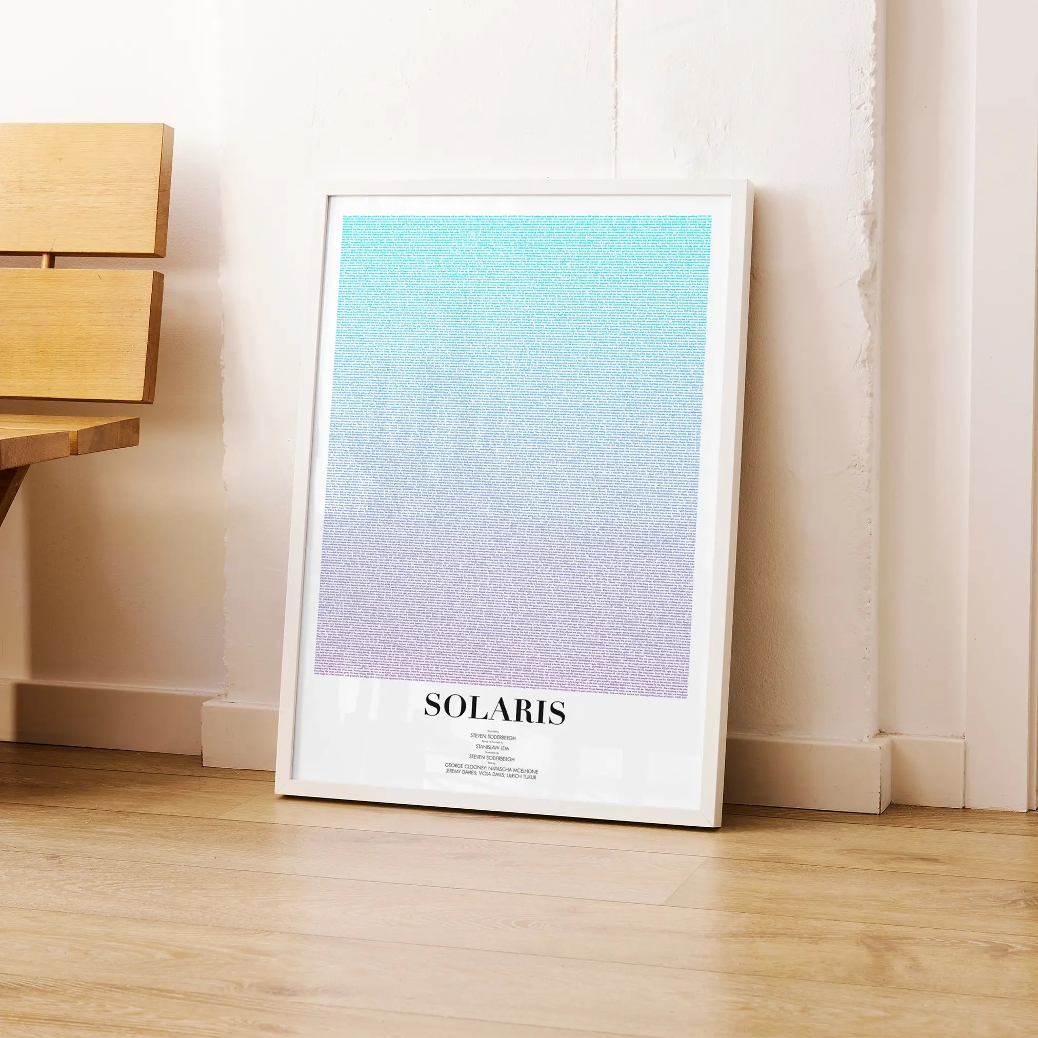 A framed Solaris movie script poster leaning against a wall in a modern interior.