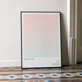 A framed Spirited Away movie script poster leaning against a wall in a minimalist interior.