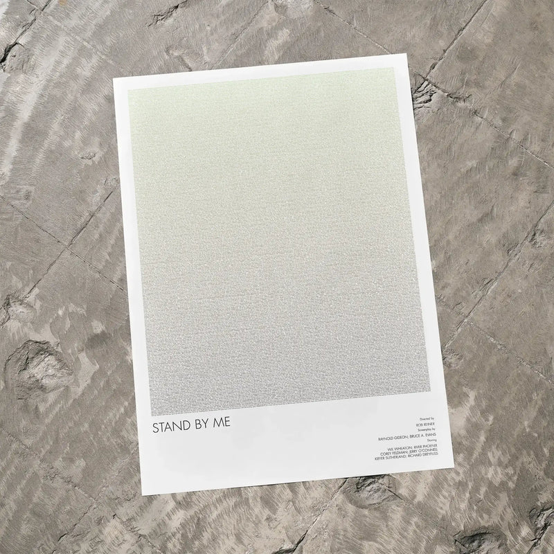 A Stand by Me movie script poster laid flat on a textured floor surface.