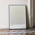 A framed Stand by Me movie script poster leaning against a wall in a minimalist interior.
