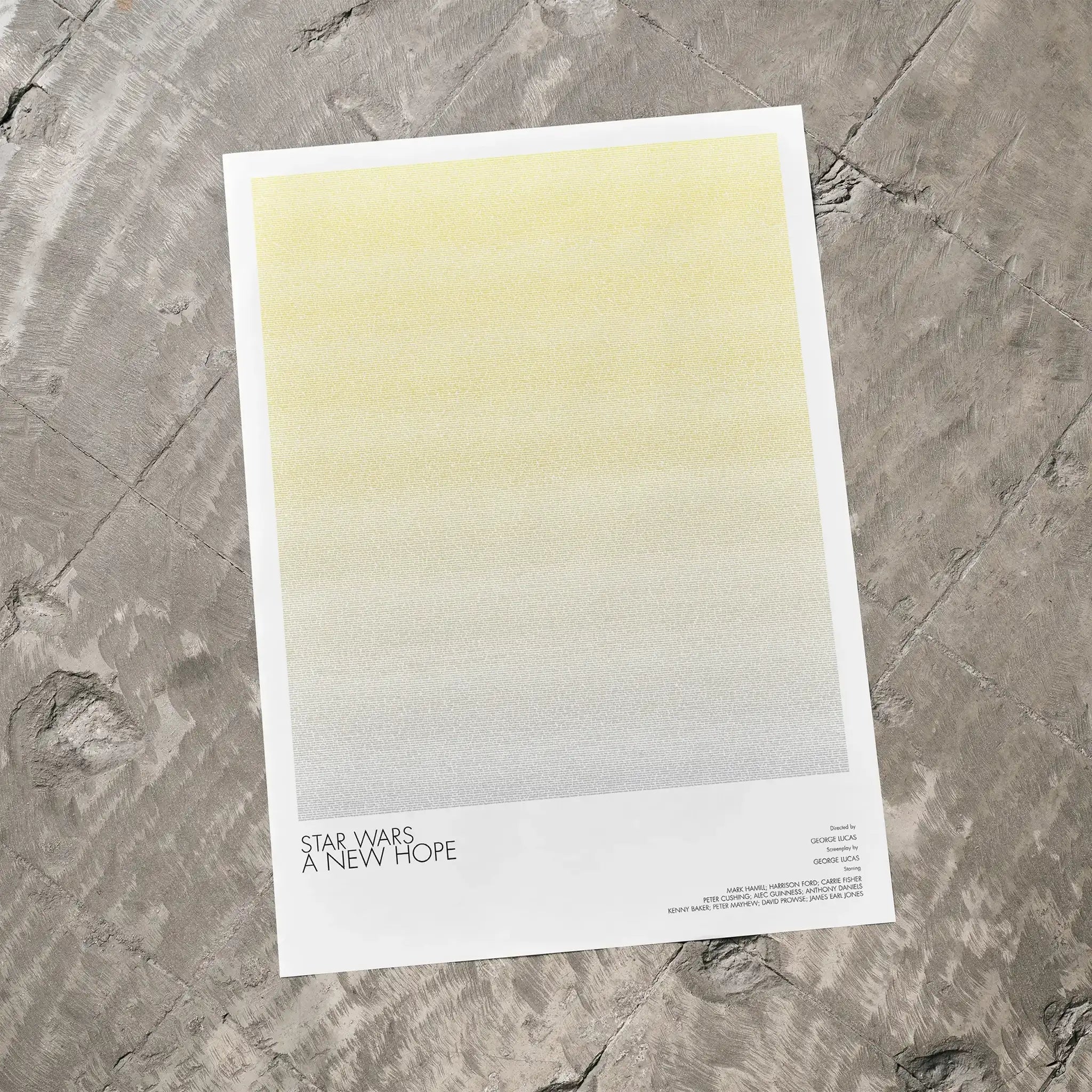 A Star Wars: A New Hope movie script poster laid flat on a textured floor surface.