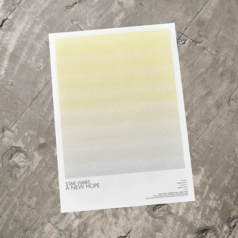 A Star Wars: A New Hope movie script poster laid flat on a textured floor surface.
