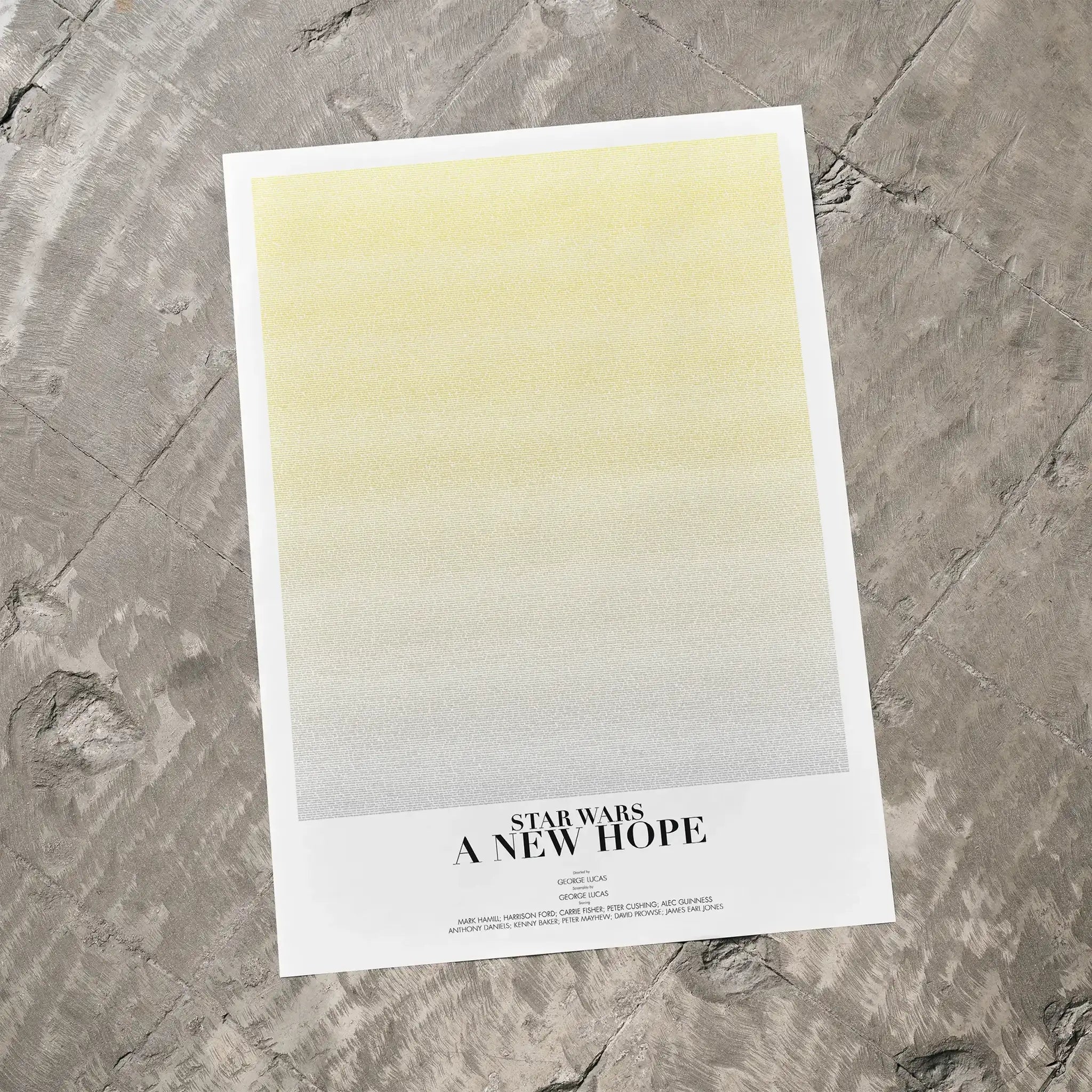 A Star Wars: A New Hope movie script poster laid flat on a textured floor surface.