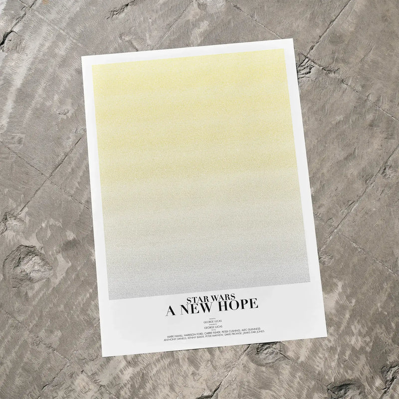 A Star Wars: A New Hope movie script poster laid flat on a textured floor surface.