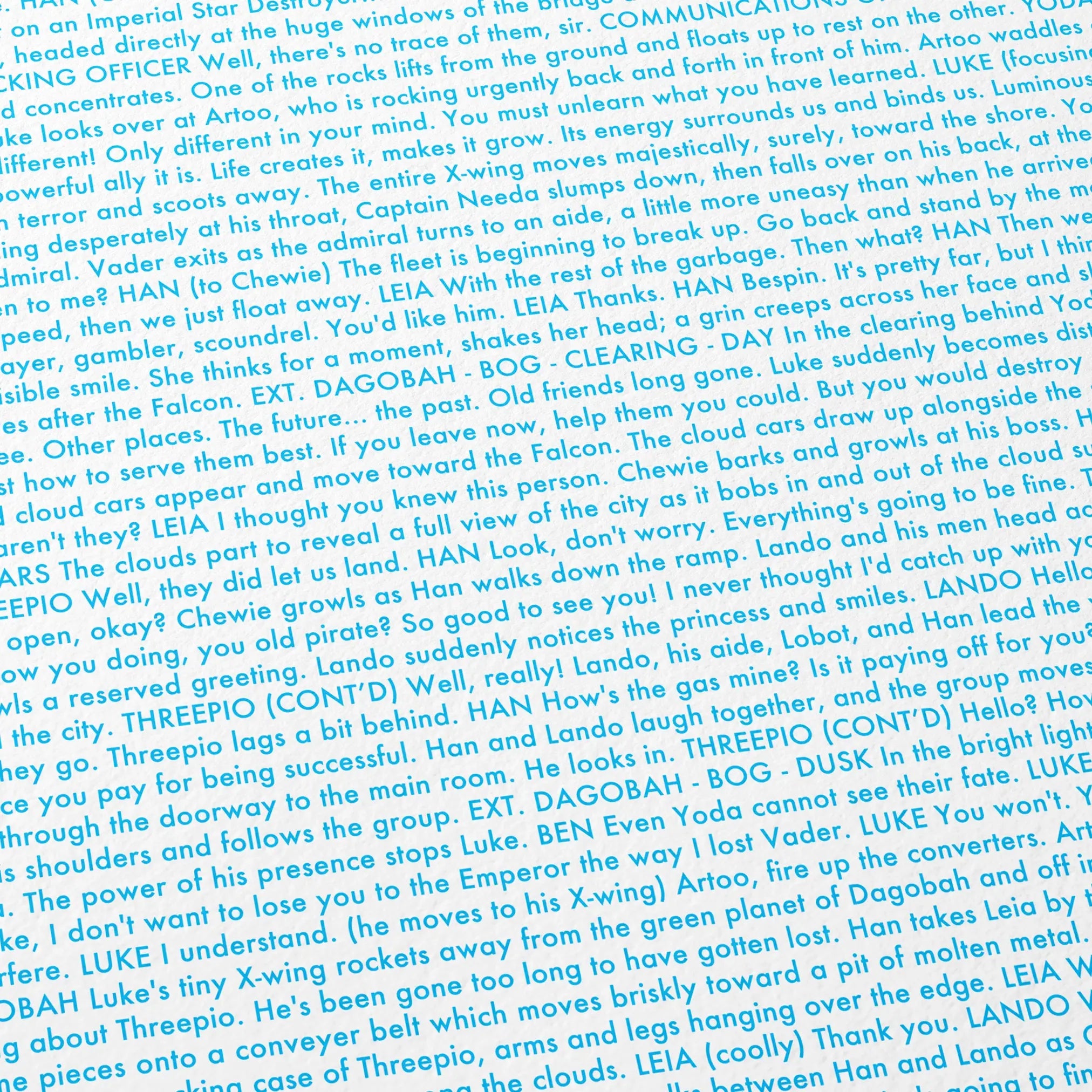 Close-up detail of the Star Wars: The Empire Strikes Back movie script poster showing dense typographic text.