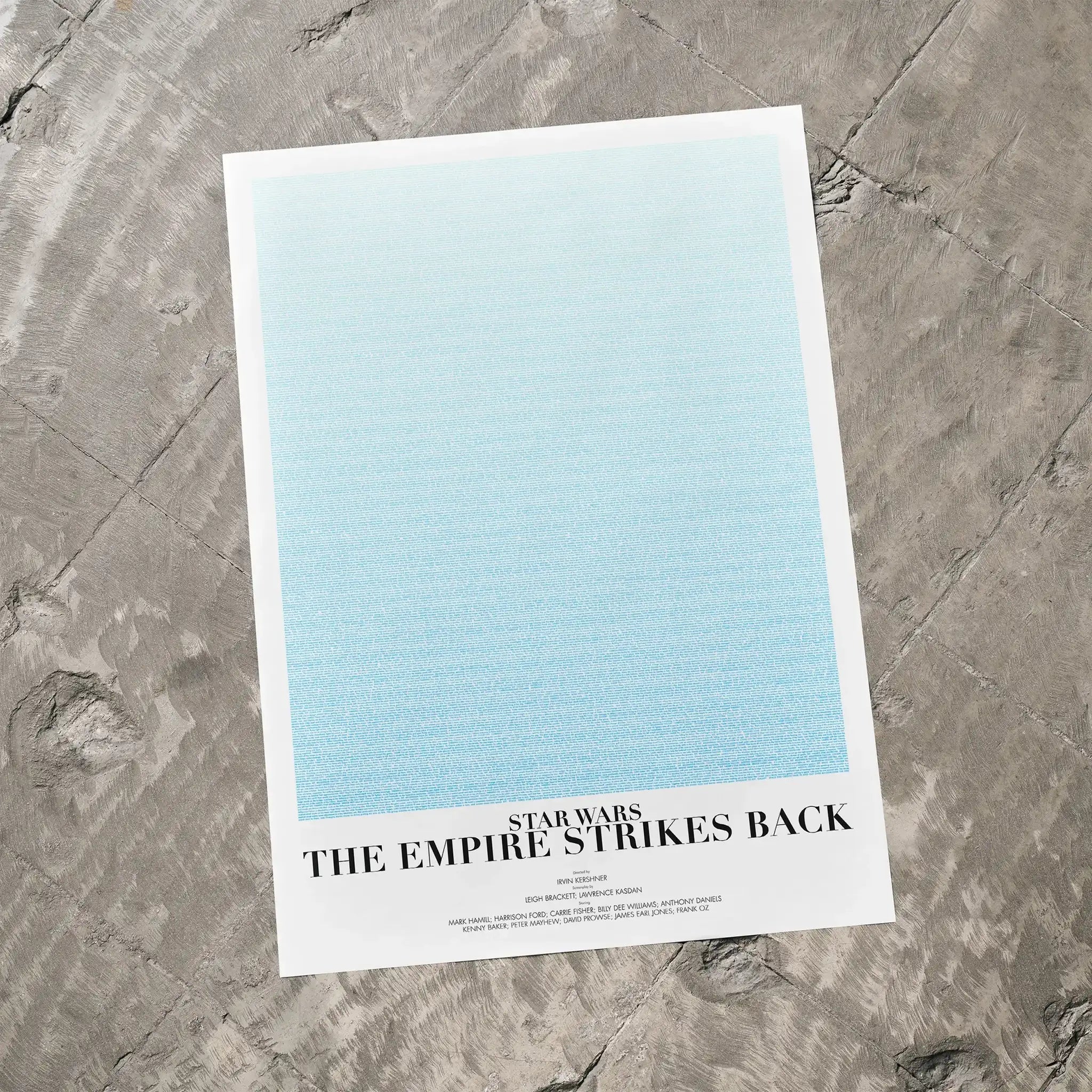 A Star Wars: The Empire Strikes Back movie script poster laid flat on a textured floor surface.