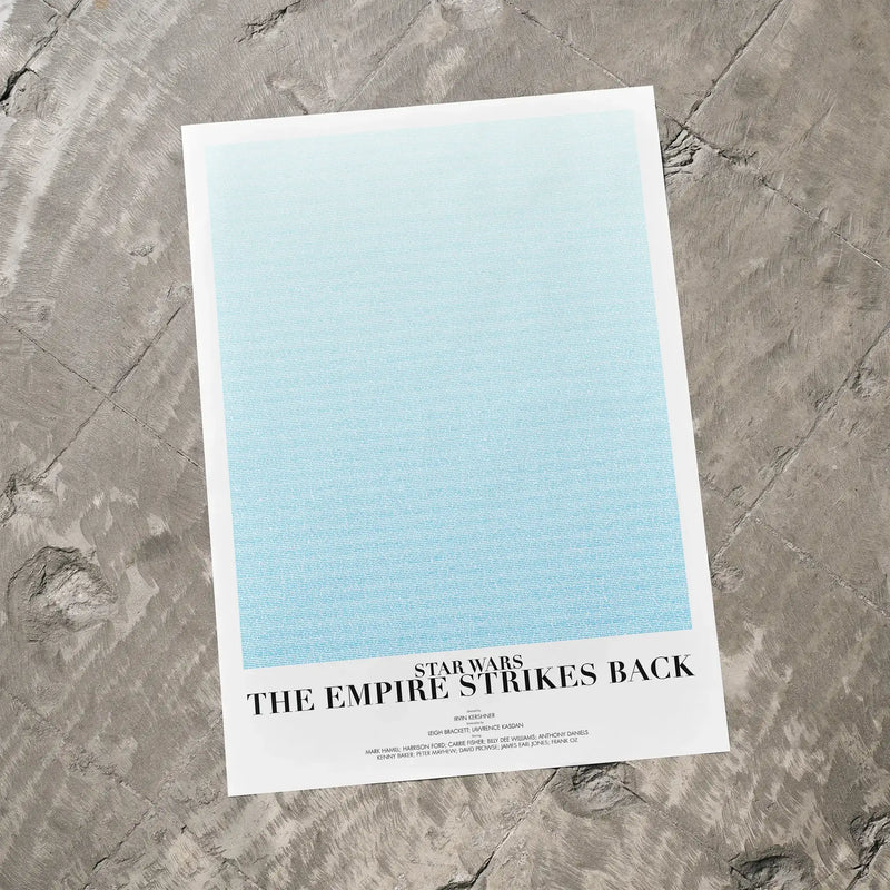 A Star Wars: The Empire Strikes Back movie script poster laid flat on a textured floor surface.