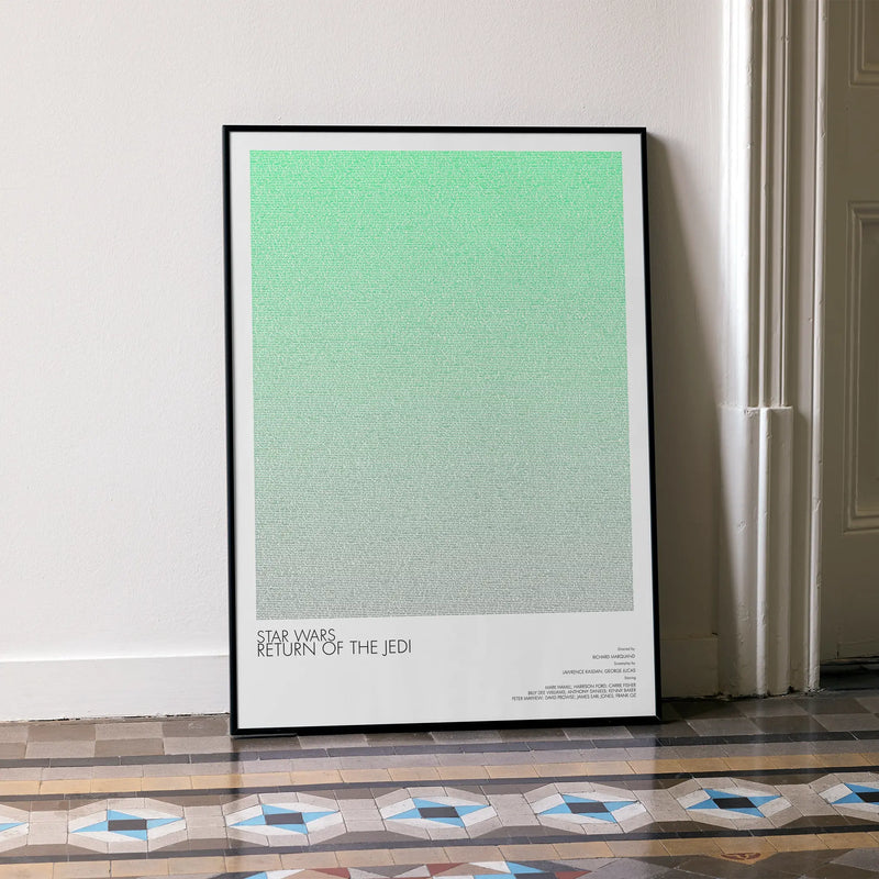 A framed Star Wars: Return of the Jedi movie script poster leaning against a wall in a minimalist interior.