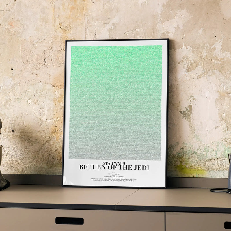 A framed Star Wars: Return of the Jedi movie script poster displayed on a cabinet in a minimalist interior.