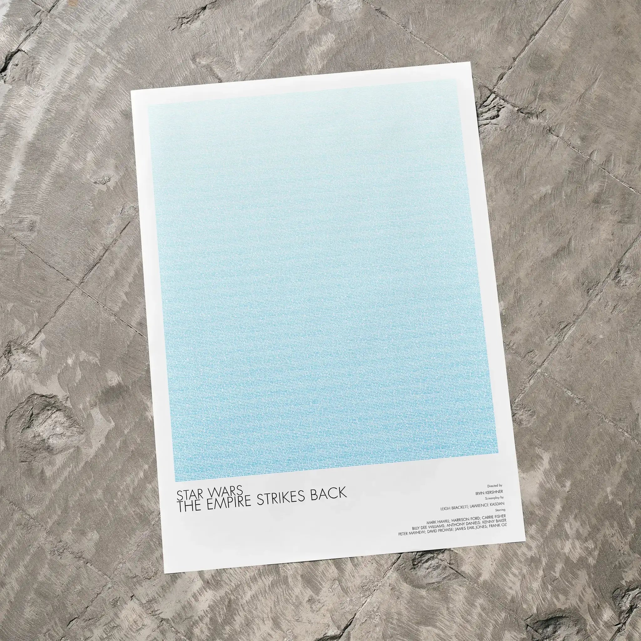 A Star Wars: The Empire Strikes Back movie script poster laid flat on a textured floor surface.