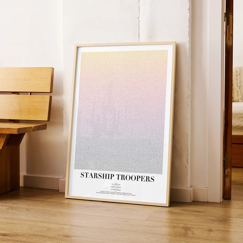 A framed Starship Troopers movie script poster arranged in a minimalist interior setting.