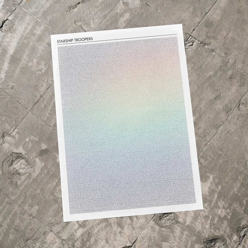 A Starship Troopers movie script poster laid flat on a textured floor surface.