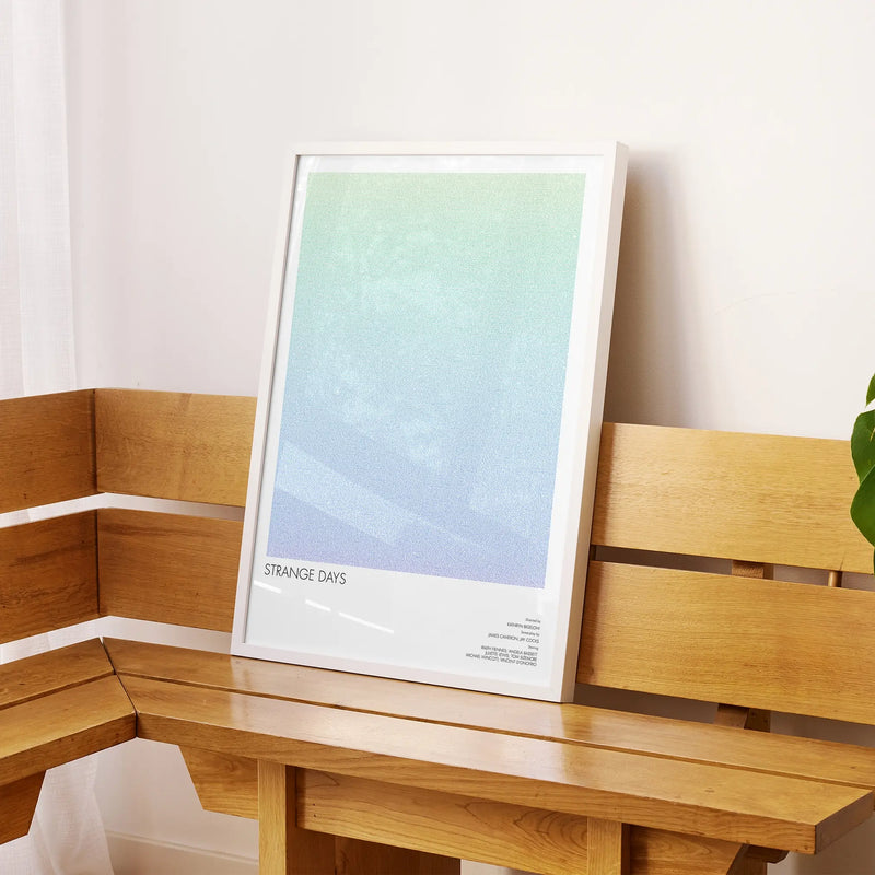 A framed Strange Days movie script poster displayed on a sideboard in a contemporary space.