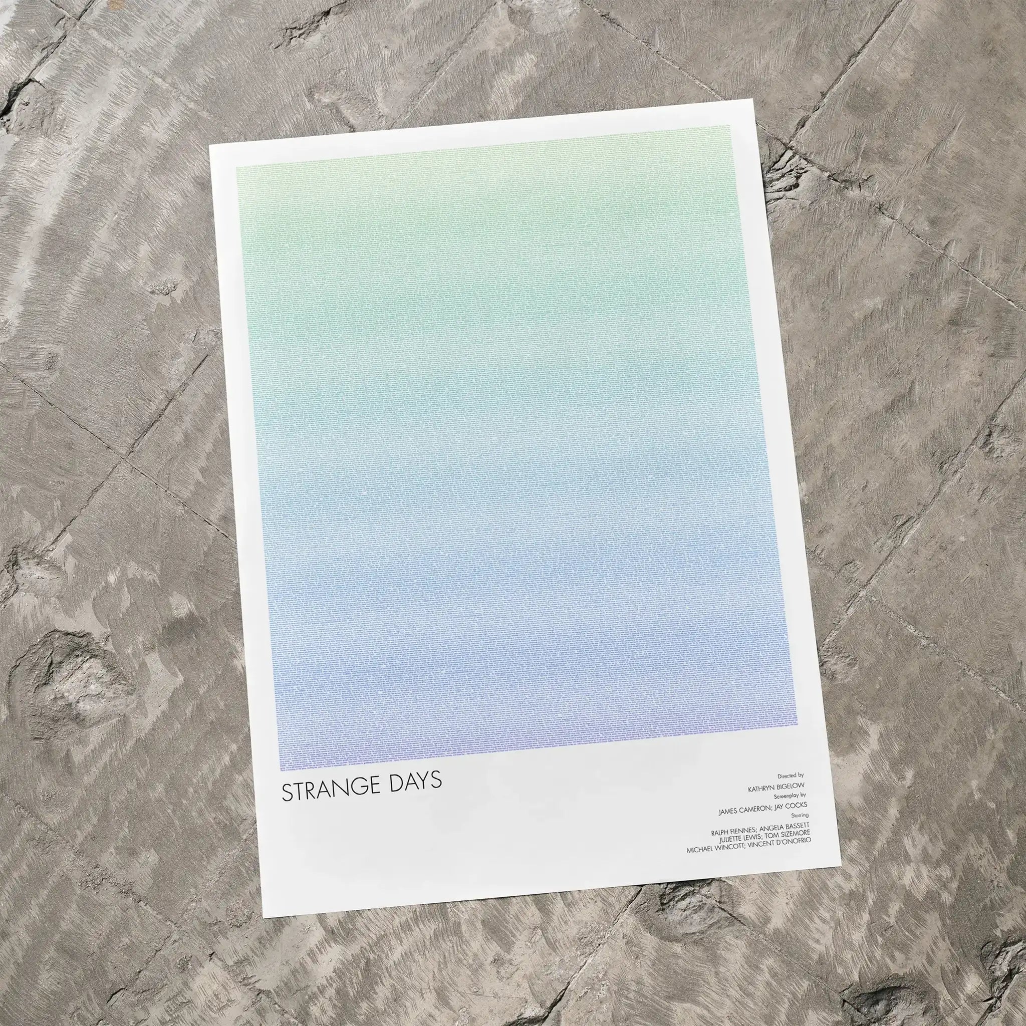 A Strange Days movie script poster laid flat on a textured floor surface.
