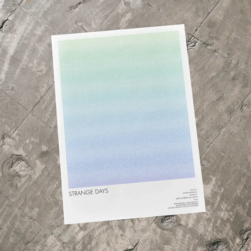 A Strange Days movie script poster laid flat on a textured floor surface.