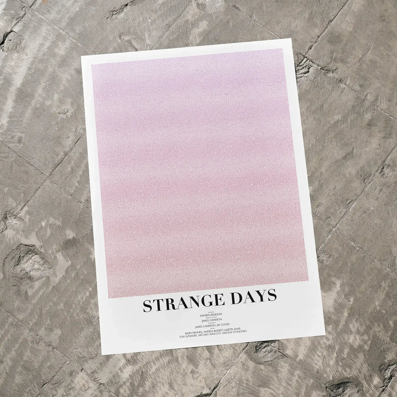 A Strange Days movie script poster laid flat on a textured floor surface.