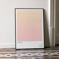 A framed Superbad movie script poster leaning against a wall in a minimalist interior.