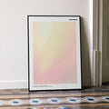 A framed Superbad movie script poster leaning against a wall in a minimalist interior.